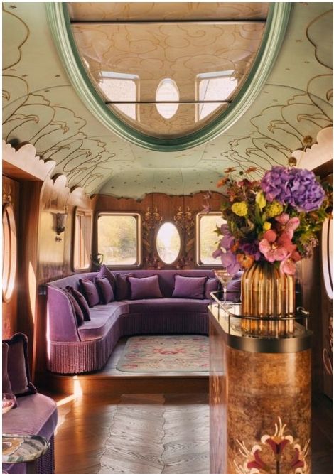 Pullman lounge with curved purple seating and floral arrangements